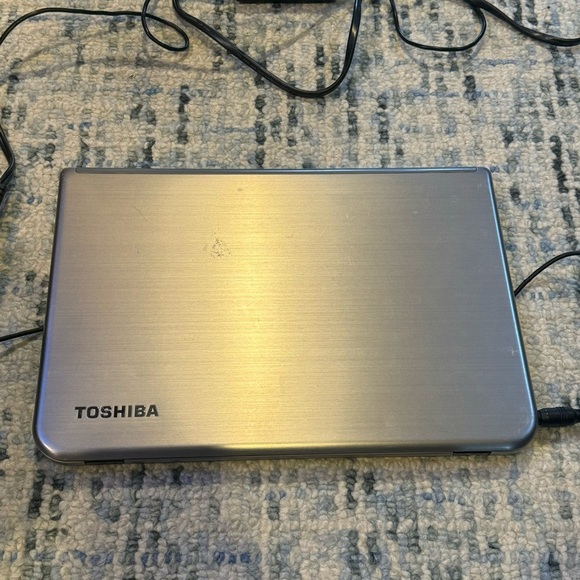 Toshiba Silver Laptop with Modern Design and Portability - Picture 1 of 11
